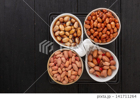 assorted peanut dishes including vinegar soaked fried and boiled peanuts in four compartments assorted peanut dishes including vinegar soaked fried and boiled peanuts in four compartments 141711264