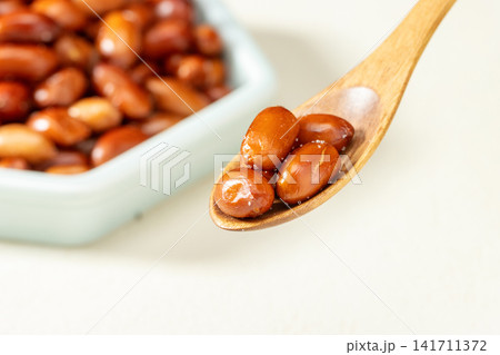 deep fried peanuts served in a hexagonal plate with chopsticks deep fried peanuts served in a hexagonal plate with chopsticks 141711372