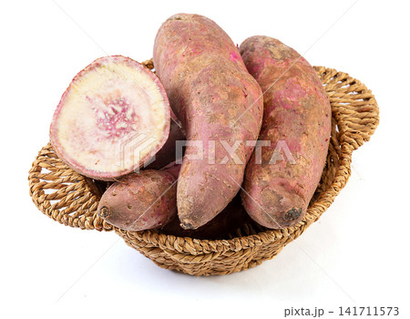 raw purple flesh sweet potato whole and cross section 141711573