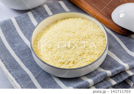 yellow potato flakes and starch powder in ceramic bowl yellow potato flakes and starch powder in ceramic bowl 141711703
