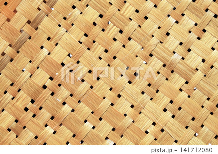 natural woven bamboo mat featuring an authentic handcrafted texture and traditional weaving pattern. This versatile background is ideal for interior design presentations, product photography 141712080
