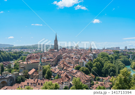 Panoramic view of Bern old town from Rose Garden Rosengarten, capital city of Switzerland. Scenic landscape with Aare River loop and Bern Cathedral Minster tower, famous Europe travel destination Panoramic view of Bern old town from Rose Garden Rosengarten, capital city of Switzerland. Scenic landscape with Aare River loop and Bern Cathedral Minster tower, famous Europe travel destination 141713394