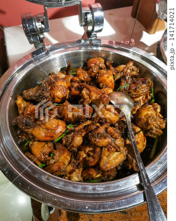 Traditional Indonesian butter fried chicken coated with rich soy butter sauce and served buffet style. Asian comfort food for hospitality, catering, restaurant and menu concepts. 141714021