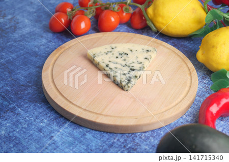 blue cheese and vegetables on a wooden board blue cheese and vegetables on a wooden board 141715340