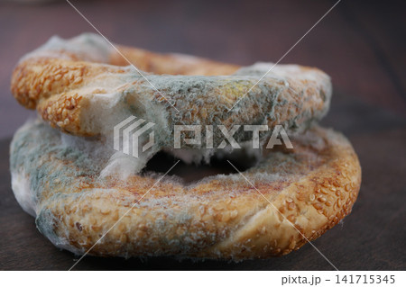 Moldy bagels on a wooden surface 141715345