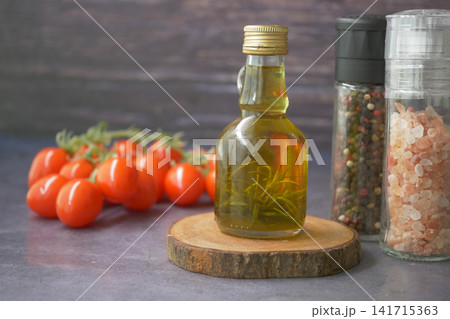 Tomato, oil, and spices on a wooden surface Tomato, oil, and spices on a wooden surface 141715363