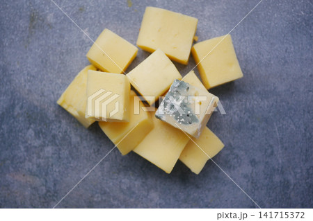 mold cheese cubes placed on a gray surface in a kitchen 141715372