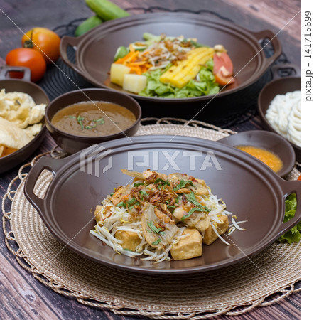Tahu gimbal Indonesian traditional dish with tofu shrimp fritters bean sprouts and peanut sauce Asian street food cuisine Tahu gimbal Indonesian traditional dish with tofu shrimp fritters bean sprouts and peanut sauce Asian street food cuisine 141715699