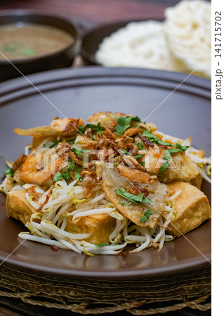 Tahu gimbal Indonesian traditional dish with tofu shrimp fritters bean sprouts and peanut sauce Asian street food cuisine Tahu gimbal Indonesian traditional dish with tofu shrimp fritters bean sprouts and peanut sauce Asian street food cuisine 141715702