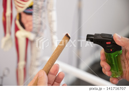 Close-up of a practitioner's hands with a lighter Close-up of a practitioner's hands with a lighter 141716707