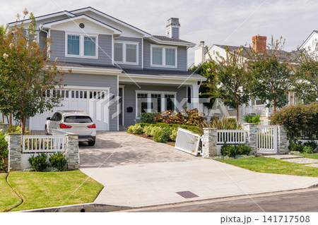 Modern suburban houses with cars in quiet residential street 141717508