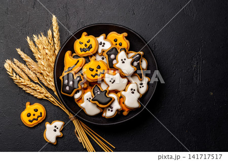 Halloween cookies on black stone background with copy space Halloween cookies on black stone background with copy space 141717517