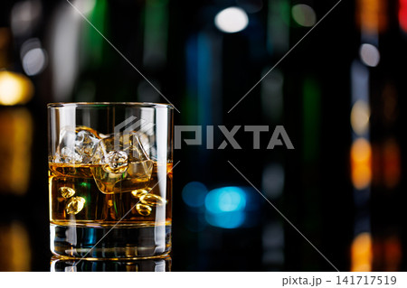 Whiskey on the rocks on a bar table 141717519