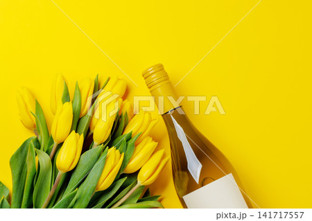White wine bottle with yellow tulips White wine bottle with yellow tulips 141717557