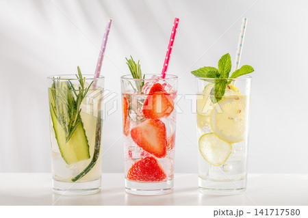Set of fresh non alcoholic drinks with strawberry cucumber and lemon on white background 141717580
