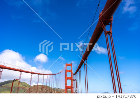 Golden Gate Bridge pedestrian walkway with red cables and blue sky 141717870