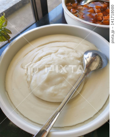 Authentic Indonesian bubur sumsum served in a ceramic bowl. Traditional creamy rice flour pudding suitable for food culture, hospitality, travel, culinary, and editorial projects. 141718080
