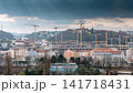 Prague urban skyline with large construction cranes and modern development beneath dramatic storm clouds, showing rapid city growth and changing architecture in Prague City Czech Republic 141718431