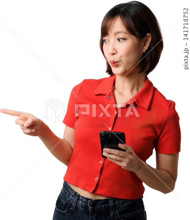 Asian woman smartphone pointing red shirt holding phone and gesturing with curious expression against isolated background Asian woman smartphone pointing red shirt holding phone and gesturing with curious expression against isolated background 141718752