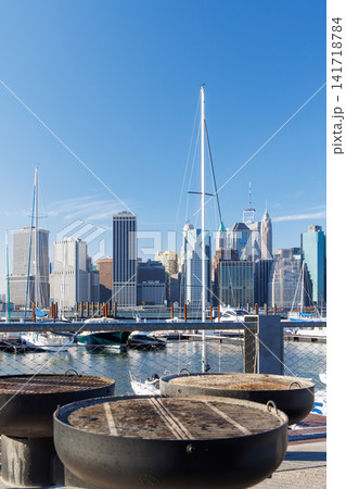 An empty outdoor barbecue grill set against a blurred view of the Manhattan skyline An empty outdoor barbecue grill set against a blurred view of the Manhattan skyline 141718784