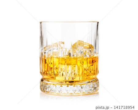 Whiskey glass with ice on white background Whiskey glass with ice on white background 141718954