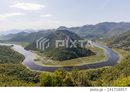 Winding river canyon with green mountains aerial view Winding river canyon with green mountains aerial view 141718957