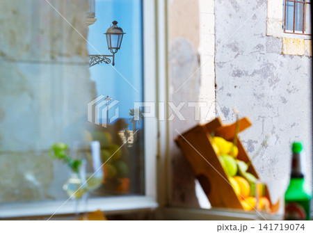 Vintage South Italian street scene with fruit box and lantern reflection Vintage South Italian street scene with fruit box and lantern reflection 141719074