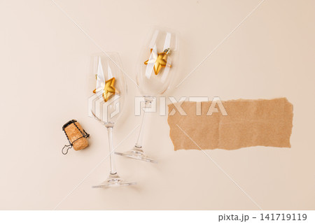 Champagne glasses and decor on beige background 141719119