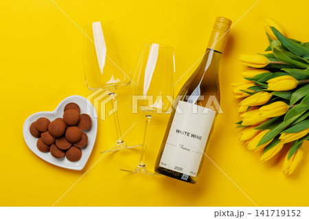 White wine bottle with yellow tulips White wine bottle with yellow tulips 141719152