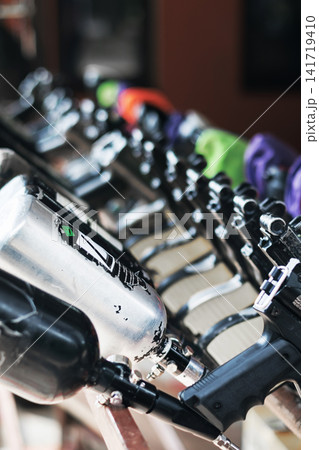 Paintball guns in a row, close up with selective focus Paintball guns in a row, close up with selective focus 141719410
