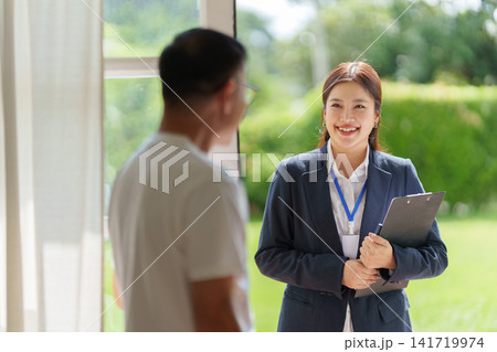 Asian insurance agent visiting client at home for financial consultation Asian insurance agent visiting client at home for financial consultation 141719974