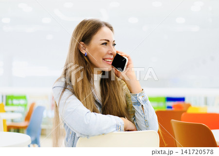 Customer Talking on Smartphone in Food Court 141720578