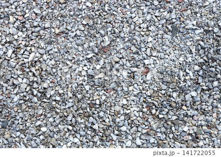 Top view texture of small crushed gray gravel stones. Ideal as natural rock background for construction, landscaping, road materials, architectural visualization, game assets, and graphic design Top view texture of small crushed gray gravel stones. Ideal as natural rock background for construction, landscaping, road materials, architectural visualization, game assets, and graphic design 141722055