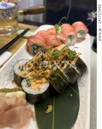 Set of assorted sushi rolls on a white plate with pickled ginger and wasabi 141722988