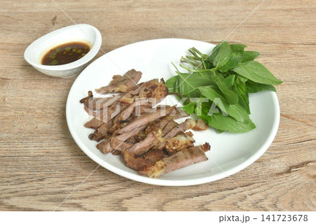 roasted slice salty beef meat with basil salad on plate dipping spicy chili sauce roasted slice salty beef meat with basil salad on plate dipping spicy chili sauce 141723678