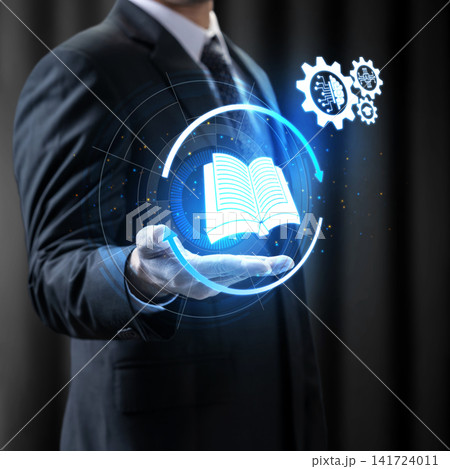 A businessman holding a glowing digital book icon with surrounding technical gear symbols, symbolizing education technology and digital learning. E-learning technology and online education concept A businessman holding a glowing digital book icon with surrounding technical gear symbols, symbolizing education technology and digital learning. E-learning technology and online education concept 141724011