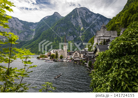 Hallstatt village and scenic lakeside in the Austrian Alps, illustrating European small town charm with classic summer atmosphere. 141724155