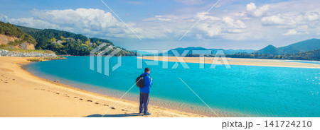 A man walks on the beach. Man looks at the sea 141724210