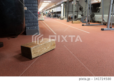 Gym interior with wooden block on rubber floor soft ambient lighting with pleasant warm tones and motivating atmosphere. Gym interior with wooden block on rubber floor soft ambient lighting with pleasant warm tones and motivating atmosphere. 141724580