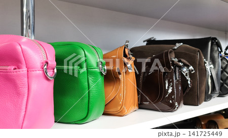 Colorful leather handbags lined up on store shelves, Colorful leather handbags lined up on store shelves, 141725449