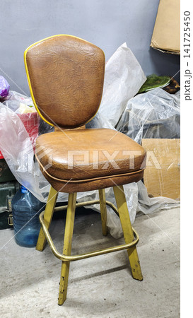 Vintage wooden chair with a worn leather seat and yellow-painted legs, Vintage wooden chair with a worn leather seat and yellow-painted legs, 141725450