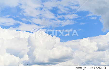 Clouds fill blue sky with bright daylight and soft shapes. Clouds fill blue sky with bright daylight and soft shapes. 141726151