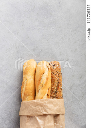 Assorted Baguettes in Paper Bag with Scattered Seeds 141726525
