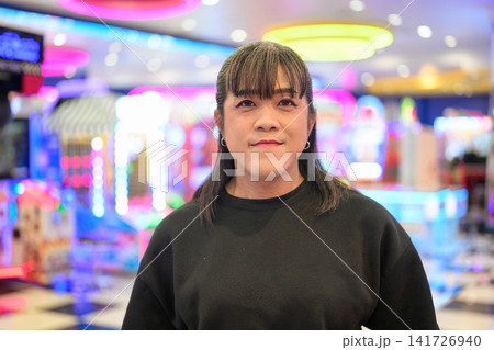 Frontal Portrait of Calm Asian Woman in Arcade Frontal Portrait of Calm Asian Woman in Arcade 141726940