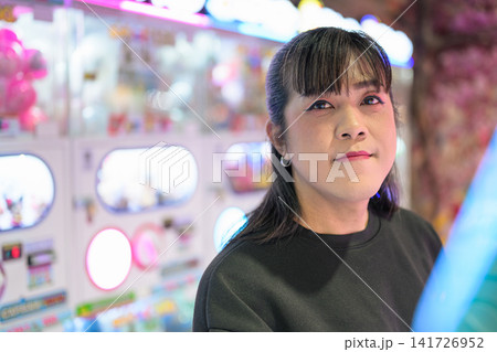 Close-Up Frontal Portrait of Asian Woman in Arcade 141726952