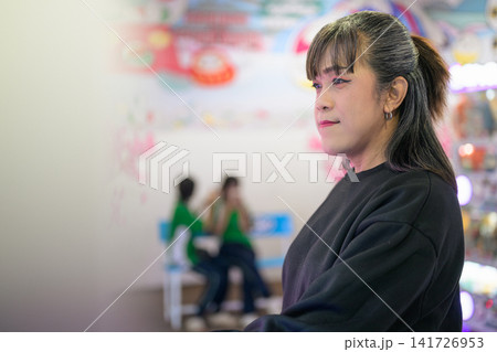 Side Profile Portrait of Woman in Arcade Game Hall Side Profile Portrait of Woman in Arcade Game Hall 141726953