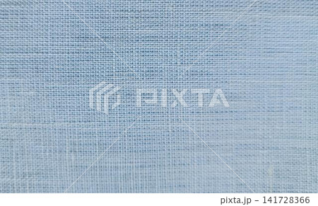 Close up of light blue fabric with a loose, mottled weave featuring thicker horizontal threads for a ribbed, striped effect. Close up of light blue fabric with a loose, mottled weave featuring thicker horizontal threads for a ribbed, striped effect. 141728366