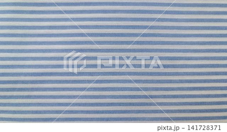 Close up of horizontally striped fabric alternating equal pastel blue and white bands. Close up of horizontally striped fabric alternating equal pastel blue and white bands. 141728371