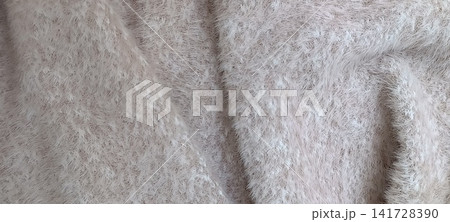 Top down close up of a very pale beige, fluffy textile with long fine fibers creating a hazy, ethereal halo. Top down close up of a very pale beige, fluffy textile with long fine fibers creating a hazy, ethereal halo. 141728390