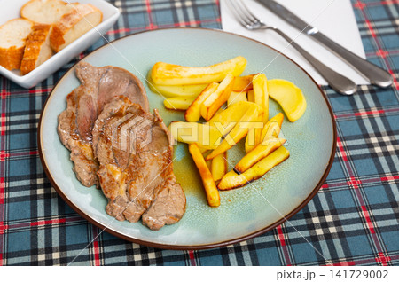 Delicious roasted veal chop served with potato 141729002